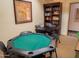 Game room with a green felt poker table and a dark wood bookcase and table at 12222 N Paradise Village S Pkwy # 405, Phoenix, AZ 85032