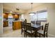 Bright kitchen with oak cabinets and dining area filled with natural light from large window at 12222 N Paradise Village S Pkwy # 405, Phoenix, AZ 85032