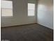 Cozy bedroom featuring plush carpet and bright, natural light from two windows at 1258 E Elaine St, Casa Grande, AZ 85122