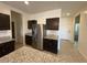 Well-lit kitchen area featuring stainless steel refrigerator and ample cabinet space at 1258 E Elaine St, Casa Grande, AZ 85122