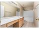 Bathroom featuring tile floors, a vanity with a sink, mirror, a shower, and a toilet at 13025 W Gelding Dr, El Mirage, AZ 85335