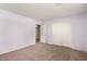 Bedroom featuring new neutral carpet, light purple walls, and sliding closet doors at 13025 W Gelding Dr, El Mirage, AZ 85335