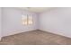 Bedroom features neutral carpet, light purple walls, and a window with horizontal blinds at 13025 W Gelding Dr, El Mirage, AZ 85335