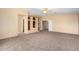 Spacious bonus room with plush carpet and custom built-in storage solutions at 13025 W Gelding Dr, El Mirage, AZ 85335