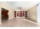 Spacious living room with tile flooring, a ceiling fan, and built-in shelves at 13025 W Gelding Dr, El Mirage, AZ 85335