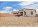 Expansive backyard featuring desert landscaping, covered patio, and seating area at 13314 W Dale Ln, Peoria, AZ 85383