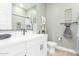 Stylish bathroom with modern vanity, framed mirror, and decorative shelving at 13314 W Dale Ln, Peoria, AZ 85383