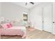 Bedroom featuring a pink bed, paper flower decorations, and a closet at 13314 W Dale Ln, Peoria, AZ 85383