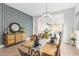 Elegant dining space featuring stylish wallpaper, decor, and a view into the living area at 13314 W Dale Ln, Peoria, AZ 85383