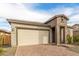 Well-maintained home with a two-car garage, brick accents, and a paver driveway at 13314 W Dale Ln, Peoria, AZ 85383