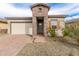 Inviting facade with brick accents, desert landscaping, and a two-car garage at 13314 W Dale Ln, Peoria, AZ 85383