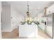 Modern kitchen with a central island, recessed lighting, and seamless flow to the living area at 13314 W Dale Ln, Peoria, AZ 85383