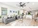 Open-concept living room with a ceiling fan, modern decor, and a view of the kitchen at 13314 W Dale Ln, Peoria, AZ 85383