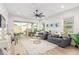 Bright living room with large sliding glass doors that bring in natural light at 13314 W Dale Ln, Peoria, AZ 85383