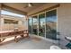 Inviting covered patio featuring a wooden picnic table and view of backyard at 13314 W Dale Ln, Peoria, AZ 85383