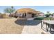 Covered patio with outdoor kitchen and backyard landscaping, including pool and spa at 13350 W La Reata Ave, Goodyear, AZ 85395