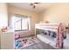 A colorful bedroom features a bunk bed, carpet, natural lighting, and storage at 13350 W La Reata Ave, Goodyear, AZ 85395