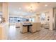 Elegant dining room featuring tile floors, modern chandelier, and open access to the living room at 13350 W La Reata Ave, Goodyear, AZ 85395