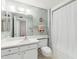 Bathroom with a shower featuring a white curtain, and a sink and toilet combination at 13354 W Stonebrook Dr, Sun City West, AZ 85375