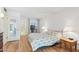 Bright bedroom featuring hardwood floors, a metal bed frame, and natural light at 13354 W Stonebrook Dr, Sun City West, AZ 85375