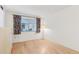 Bedroom featuring hardwood floors and a window with decorative curtains at 13354 W Stonebrook Dr, Sun City West, AZ 85375