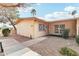 Tan home with a concrete walkway and rock landscaping, offering a secure and charming curb appeal at 13354 W Stonebrook Dr, Sun City West, AZ 85375