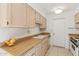 Well-lit kitchen showing countertops, a stainless steel sink, and standard appliances at 13354 W Stonebrook Dr, Sun City West, AZ 85375