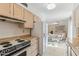 Cozy kitchen showcasing warm wooden cabinets, essential appliances, and an adjacent dining area at 13354 W Stonebrook Dr, Sun City West, AZ 85375