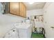 Laundry room featuring a washer, dryer, overhead cabinets, and storage at 13354 W Stonebrook Dr, Sun City West, AZ 85375