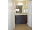 Bathroom vanity with granite countertop and dark wood cabinets providing ample storage space at 1340 N Recker Rd # 254, Mesa, AZ 85205