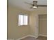 Bright bedroom with ceiling fan, window with blinds, and spacious closet with a white door at 1340 N Recker Rd # 254, Mesa, AZ 85205