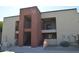 Condo building with private patios, desert landscaping, and stairway access at 1340 N Recker Rd # 254, Mesa, AZ 85205