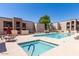 Community pool area featuring a hot tub and lounge chairs on a sunny day with blue skies at 1340 N Recker Rd # 254, Mesa, AZ 85205