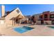 Community pool area featuring a hot tub and lounge chairs on a sunny day with blue skies at 1340 N Recker Rd # 254, Mesa, AZ 85205