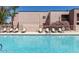 Community pool area featuring chaise lounge chairs and tables for residents to enjoy at 1340 N Recker Rd # 254, Mesa, AZ 85205