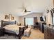 Spacious bedroom featuring a ceiling fan, neutral walls, carpet, and dark furniture with a decorative bench at 1357 N Balboa Dr, Gilbert, AZ 85234