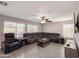 Bright living room features sectional sofa, ceiling fan, and lots of natural light from large windows at 1357 N Balboa Dr, Gilbert, AZ 85234