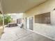 Covered back patio area with tiled flooring, a hot tub in the backyard, and sliding glass doors at 1357 N Balboa Dr, Gilbert, AZ 85234