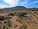 Elevated view of the sprawling desert property with mountain views, highlighting the natural surroundings at 13935 E Smokehouse Trl, Scottsdale, AZ 85262