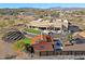 A high-angle shot of a custom home with guest casita, landscaping, outdoor entertaining area, and desert surroundings at 13935 E Smokehouse Trl, Scottsdale, AZ 85262