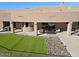 Backyard featuring artificial grass, desert landscaping, and covered patio, providing a relaxing outdoor retreat at 13935 E Smokehouse Trl, Scottsdale, AZ 85262