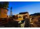 Backyard featuring rustic decor, a windmill, outdoor seating, landscaping, and string lights at 13935 E Smokehouse Trl, Scottsdale, AZ 85262