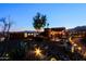 Backyard featuring rustic decor, windmill, landscaping, and desert views, illuminated with string lights at 13935 E Smokehouse Trl, Scottsdale, AZ 85262