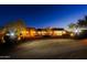 Exterior view of a custom home at dusk showcasing the architecture and desert landscaping at 13935 E Smokehouse Trl, Scottsdale, AZ 85262