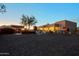 Exterior view of the home featuring a barn, a steer statue, desert landscaping, and a charming outdoor space at 13935 E Smokehouse Trl, Scottsdale, AZ 85262