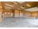 Large garage space with overhead lighting, neutral walls, and door to outside at 13935 E Smokehouse Trl, Scottsdale, AZ 85262