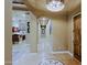 Hallway featuring tile flooring, arched doorways, decorative lighting, and rustic wood door at 13935 E Smokehouse Trl, Scottsdale, AZ 85262