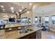 Open-concept kitchen with a stone accent wall, large island, and stainless steel appliances at 13935 E Smokehouse Trl, Scottsdale, AZ 85262