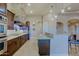 Long view of kitchen with island, stone accents, and stainless steel appliances at 13935 E Smokehouse Trl, Scottsdale, AZ 85262