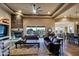 Spacious living room featuring stone fireplace, leather sofas, and scenic views at 13935 E Smokehouse Trl, Scottsdale, AZ 85262